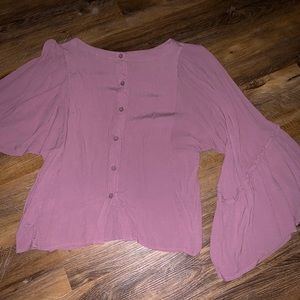 Bell sleeves with a button down back.